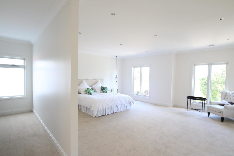 Photo of a large traditional master bedroom in Melbourne with beige walls, carpet and beige floor.