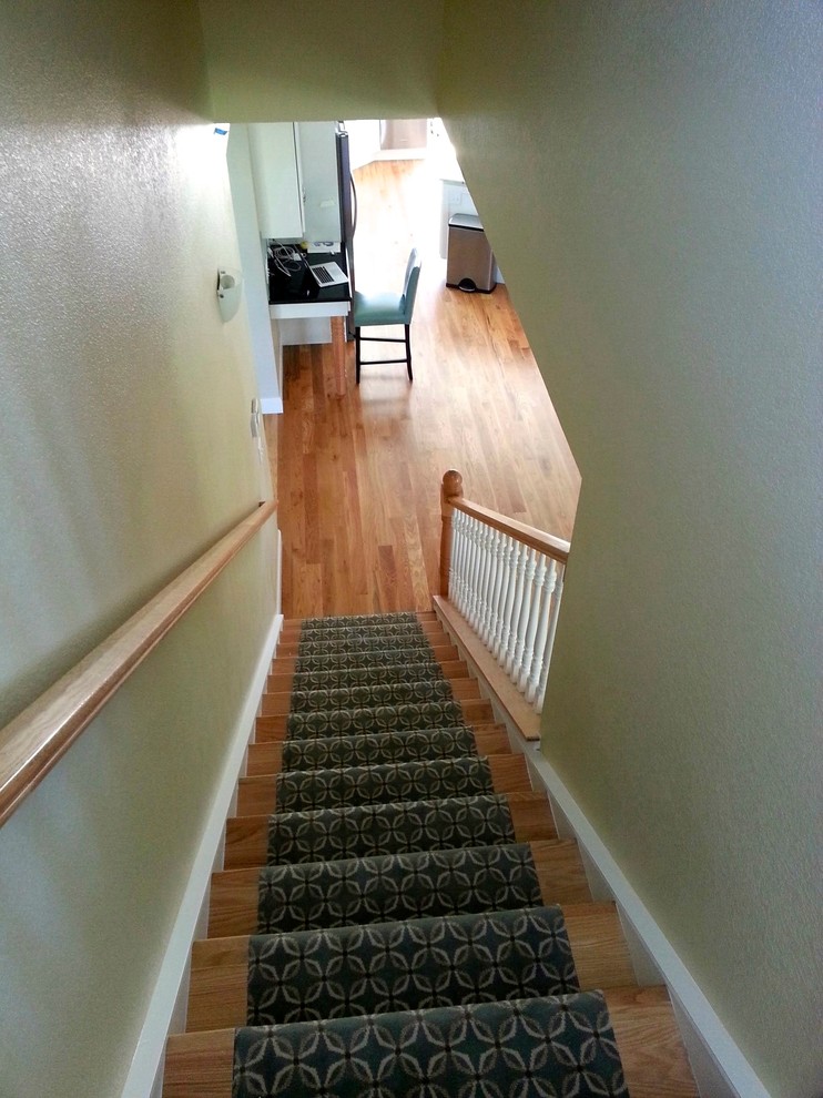 Photo of a mid-sized country carpeted straight staircase in Denver with wood risers.