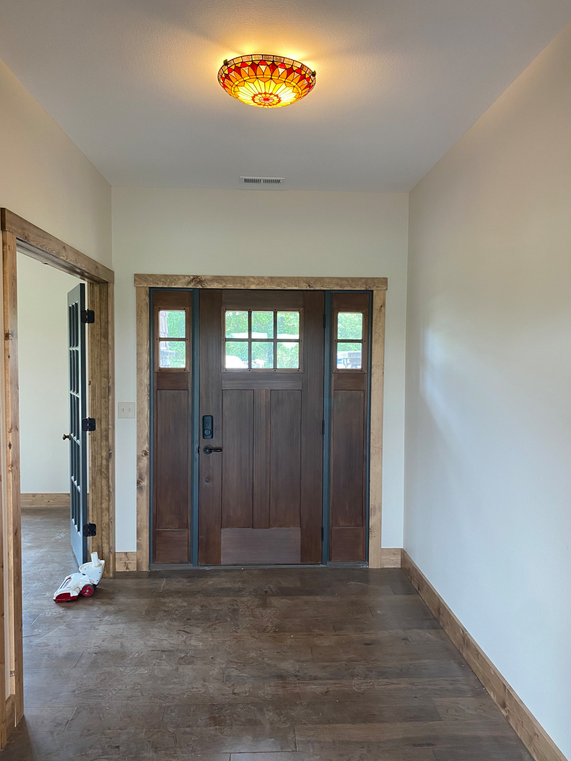 front entryway with stained pine base and case