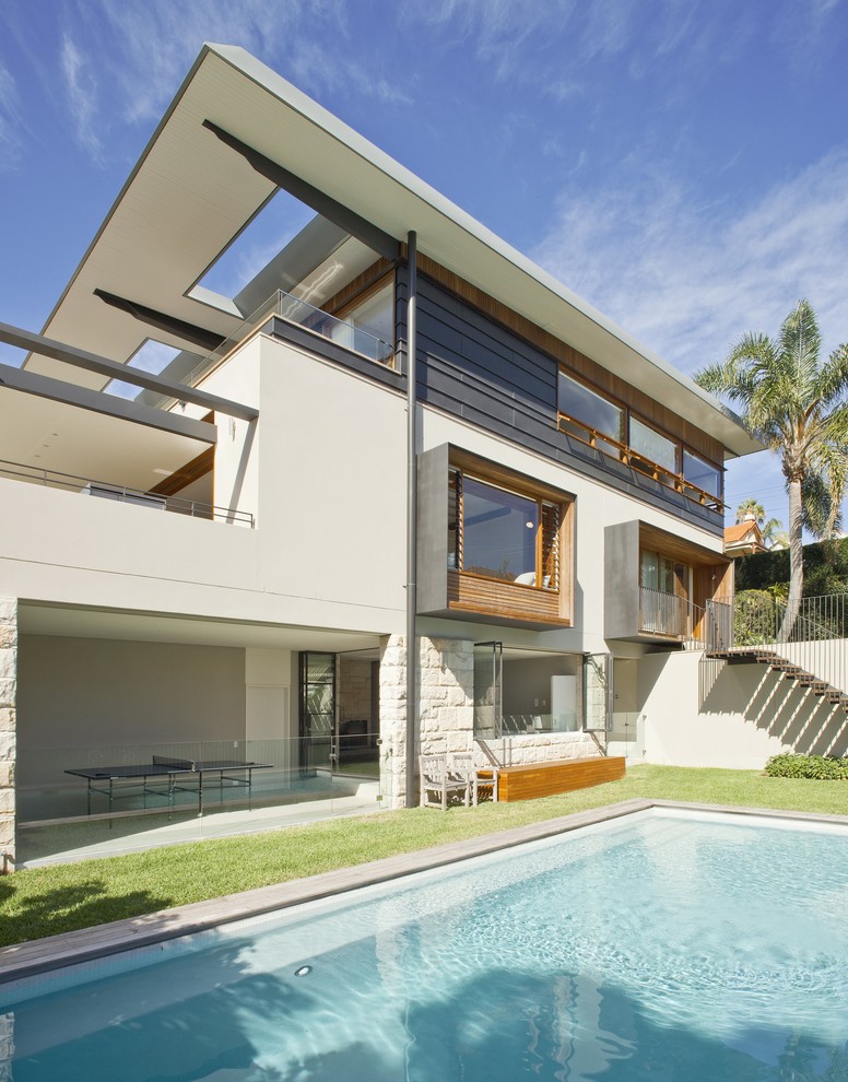 Inspiration for a large contemporary two-storey exterior in Sydney with metal siding.