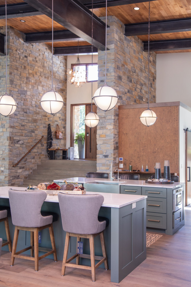 Open concept kitchen - large transitional u-shaped medium tone wood floor and brown floor open concept kitchen idea with a farmhouse sink, shaker cabinets, black cabinets, quartzite countertops, white backsplash, porcelain backsplash, stainless steel appliances, two islands and white countertops