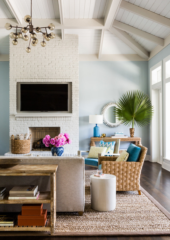 Beach style formal dark wood floor living room photo in Jacksonville with blue walls, a standard fireplace and a wall-mounted tv