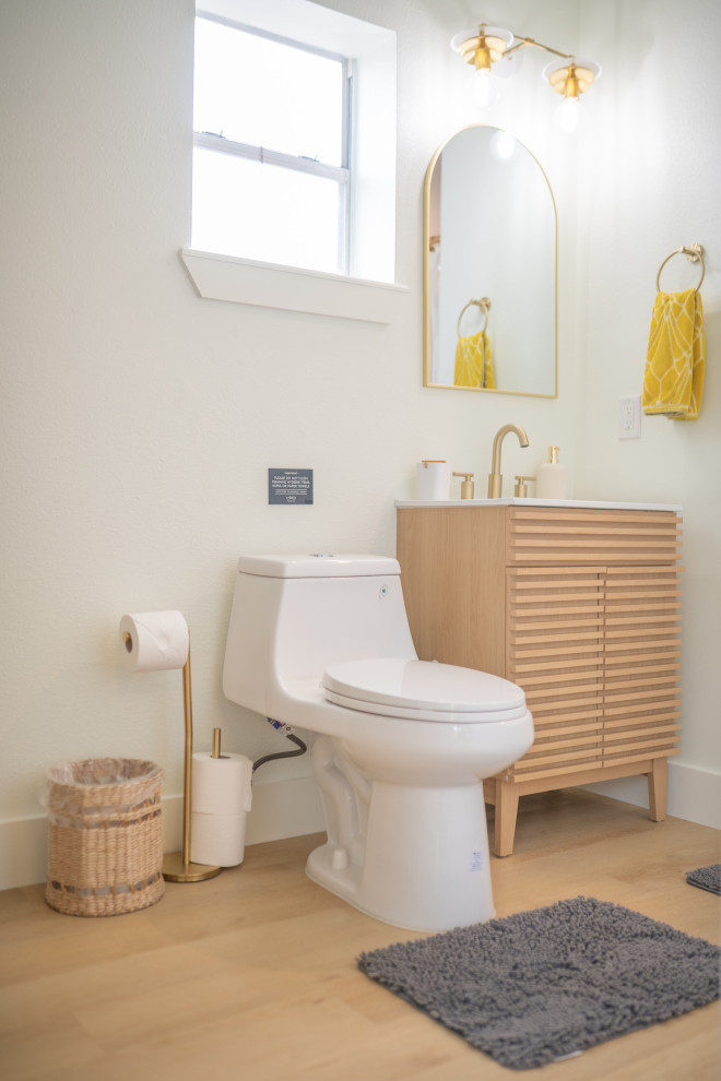 Medium sized eclectic ensuite bathroom in Austin with white cabinets, a one-piece toilet, white tiles, white walls, vinyl flooring, a built-in sink, limestone worktops, beige floors, white worktops, an enclosed toilet, a single sink, a floating vanity unit and a vaulted ceiling.