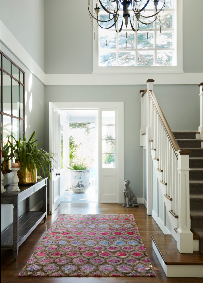 Photo of a mid-sized eclectic foyer in Sydney with grey walls, medium hardwood floors, a single front door, a white front door and brown floor.