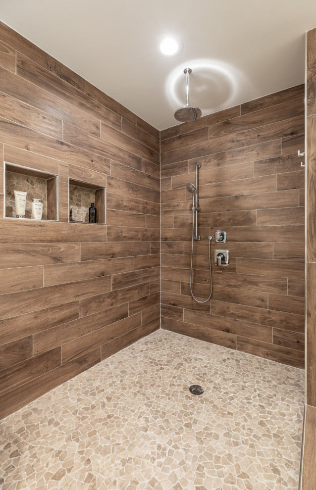 Medium sized contemporary ensuite bathroom in DC Metro with brown cabinets, a freestanding bath, a shower/bath combination, a one-piece toilet, brown tiles, grey walls, a submerged sink, grey floors, an open shower, white worktops, double sinks and a built in vanity unit.
