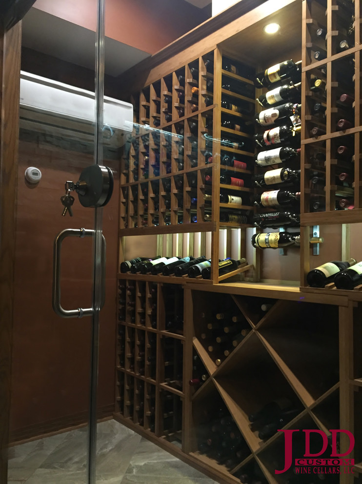 This is an example of a mid-sized traditional wine cellar in Cincinnati with porcelain floors and storage racks.
