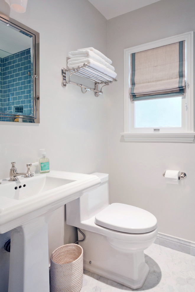 Mid-sized contemporary 3/4 bathroom in Los Angeles with an alcove shower, a one-piece toilet, blue tile, subway tile, grey walls, marble floors, a pedestal sink, grey floor and a hinged shower door.