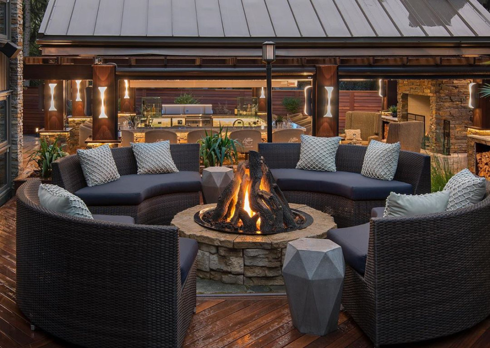 Inspiration for a large transitional backyard deck in Calgary with a fire feature and no cover.