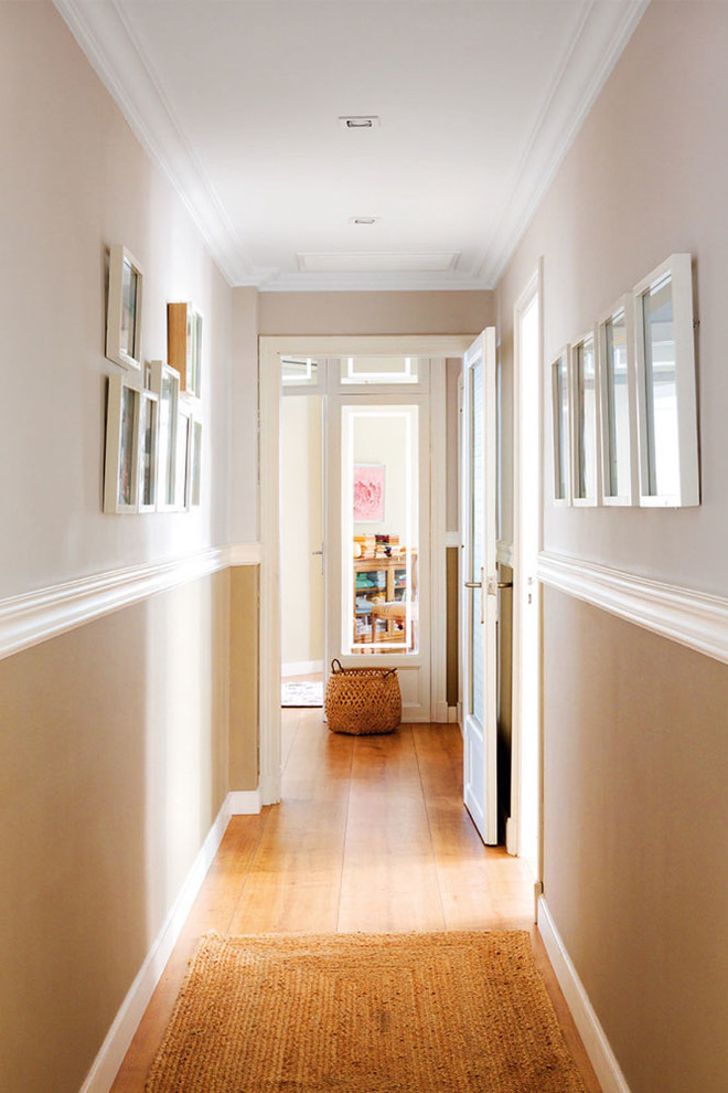 Design ideas for a large transitional hallway in Other with beige walls and medium hardwood floors.