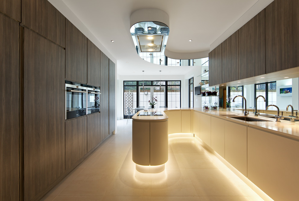 This is an example of a contemporary eat-in kitchen in Other with an undermount sink, flat-panel cabinets, dark wood cabinets and a peninsula.