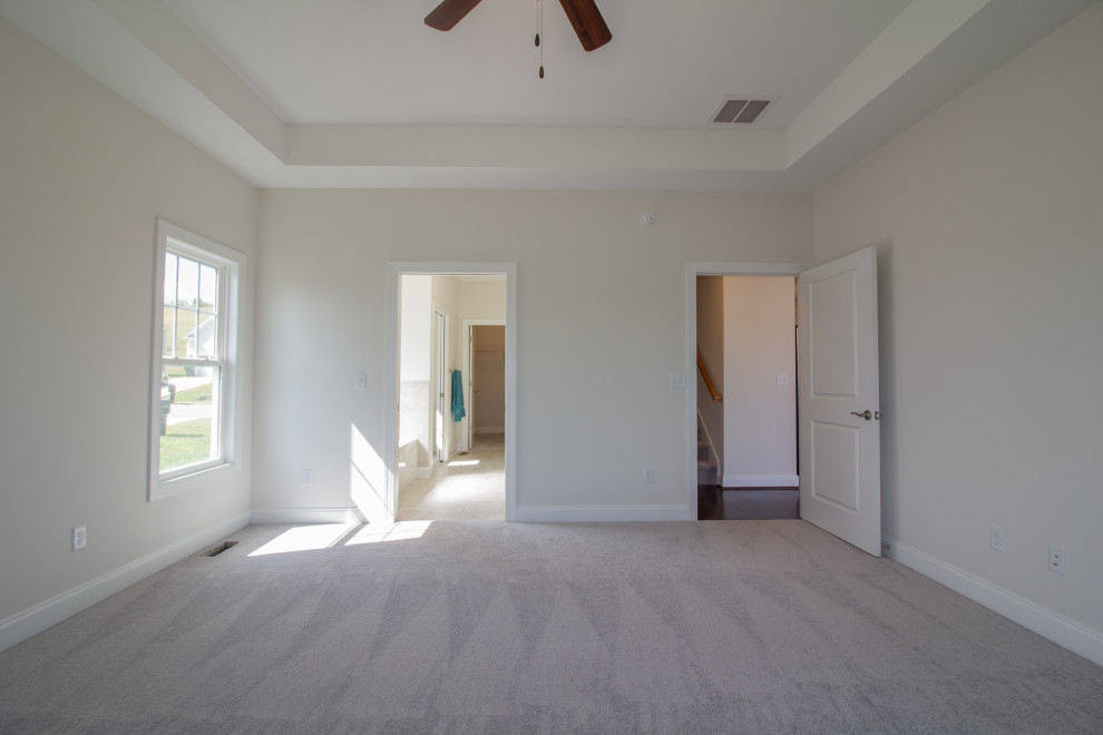 Photo of a large traditional master bedroom in Other with white walls, carpet, no fireplace, grey floors and a drop ceiling.