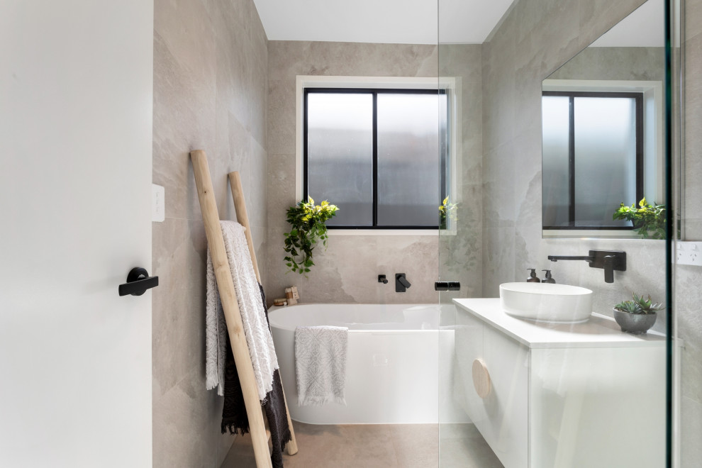 Inspiration for a small contemporary bathroom in Brisbane with an alcove tub, a corner shower, gray tile, ceramic tile, grey walls, ceramic floors, a vessel sink, grey floor, a hinged shower door, white benchtops, a single vanity and a floating vanity.