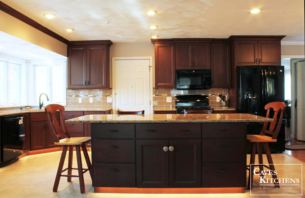 Eat-in kitchen - mid-sized transitional l-shaped vinyl floor eat-in kitchen idea with an undermount sink, flat-panel cabinets, dark wood cabinets, quartz countertops, beige backsplash, ceramic backsplash, black appliances and an island