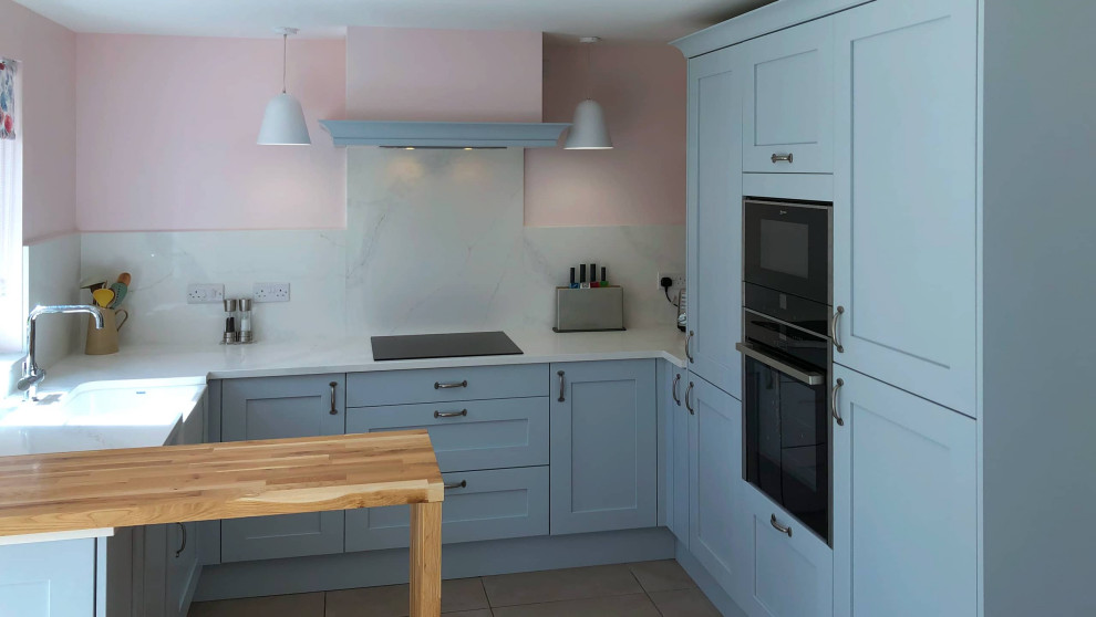 Inspiration for a small contemporary u-shaped enclosed kitchen in Edinburgh with shaker cabinets, blue cabinets and a breakfast bar.