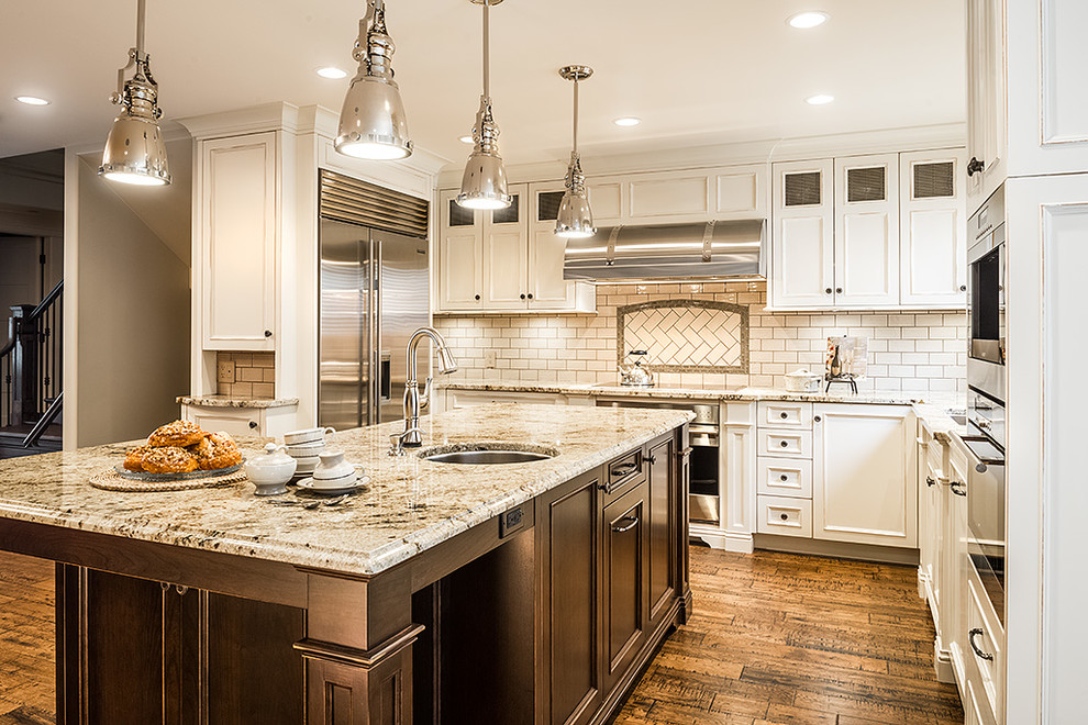 Transitional l-shaped medium tone wood floor eat-in kitchen photo in Vancouver with an undermount sink, shaker cabinets, white cabinets, granite countertops, beige backsplash, ceramic backsplash, stainless steel appliances and an island
