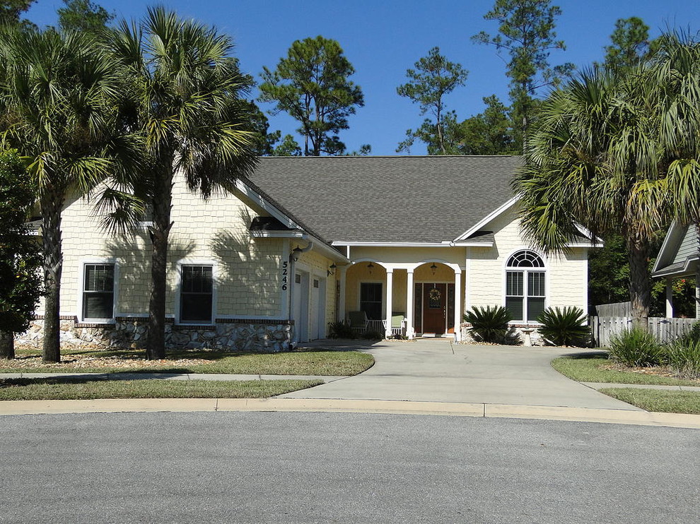 Inspiration for a mid-sized transitional yellow one-story brick exterior home remodel in Miami