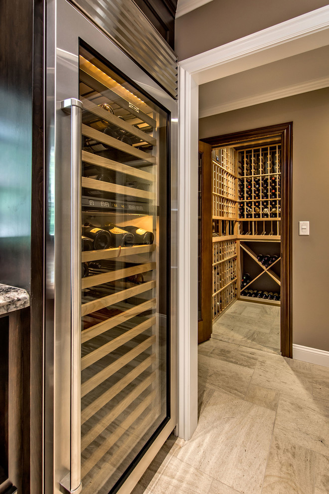Large traditional wine cellar in San Francisco with limestone floors, storage racks and beige floor.