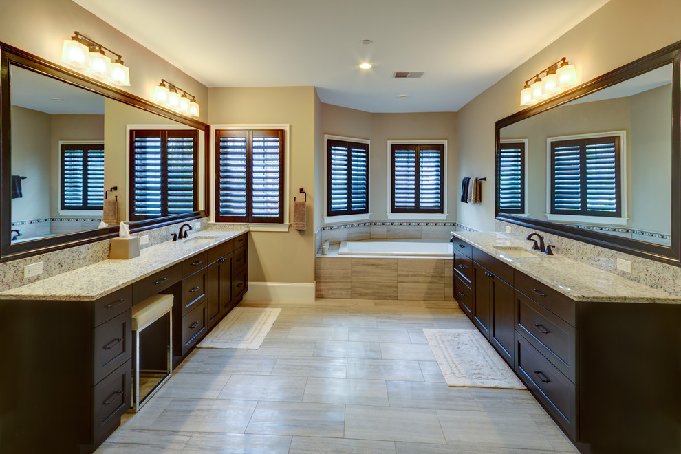 Drop-in bathtub - transitional beige tile and ceramic tile ceramic tile drop-in bathtub idea in DC Metro with an undermount sink, beaded inset cabinets, dark wood cabinets, granite countertops and gray walls