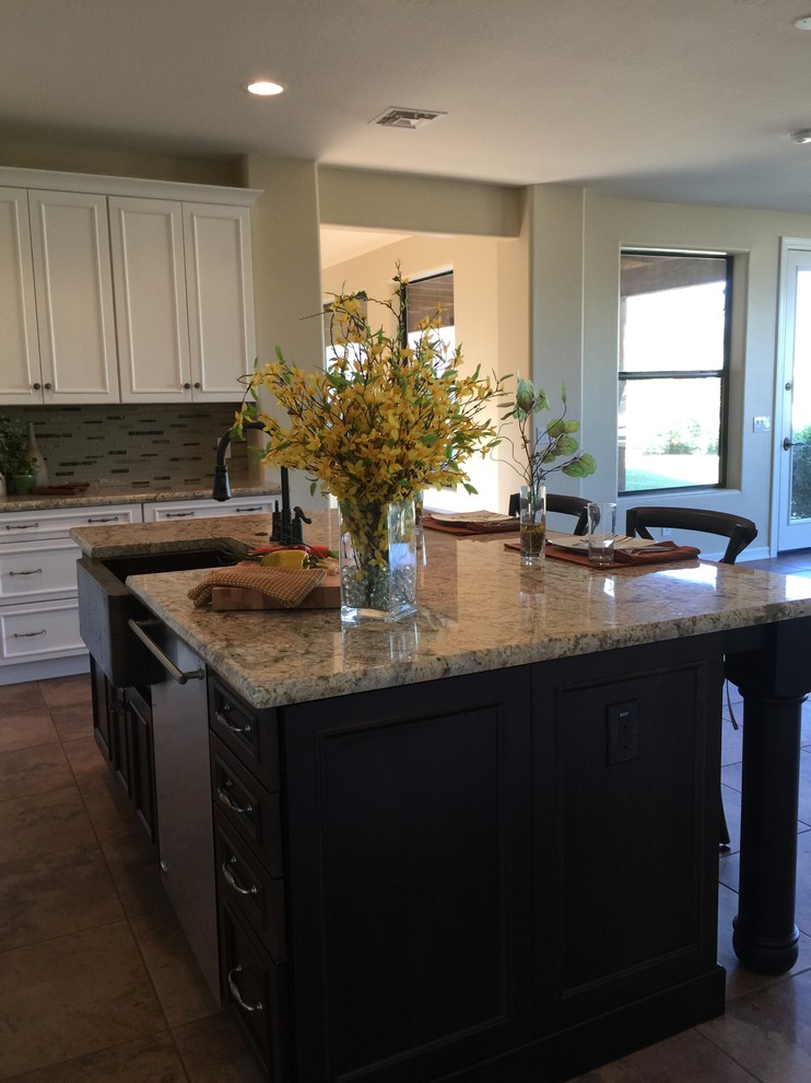 Large transitional eat-in kitchen photo in Phoenix with granite countertops, gray backsplash, stone tile backsplash, black appliances and an island