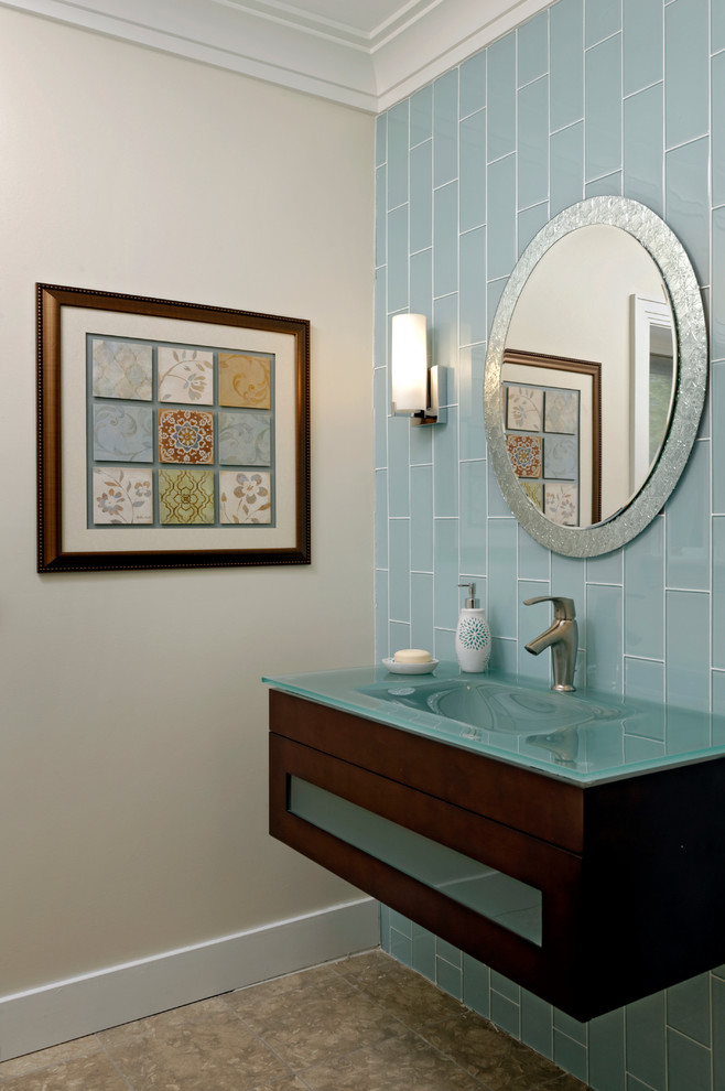 Design ideas for a mid-sized contemporary powder room in DC Metro with an integrated sink, flat-panel cabinets, dark wood cabinets, glass benchtops, blue tile, glass tile, white walls, travertine floors, beige floor and turquoise benchtops.