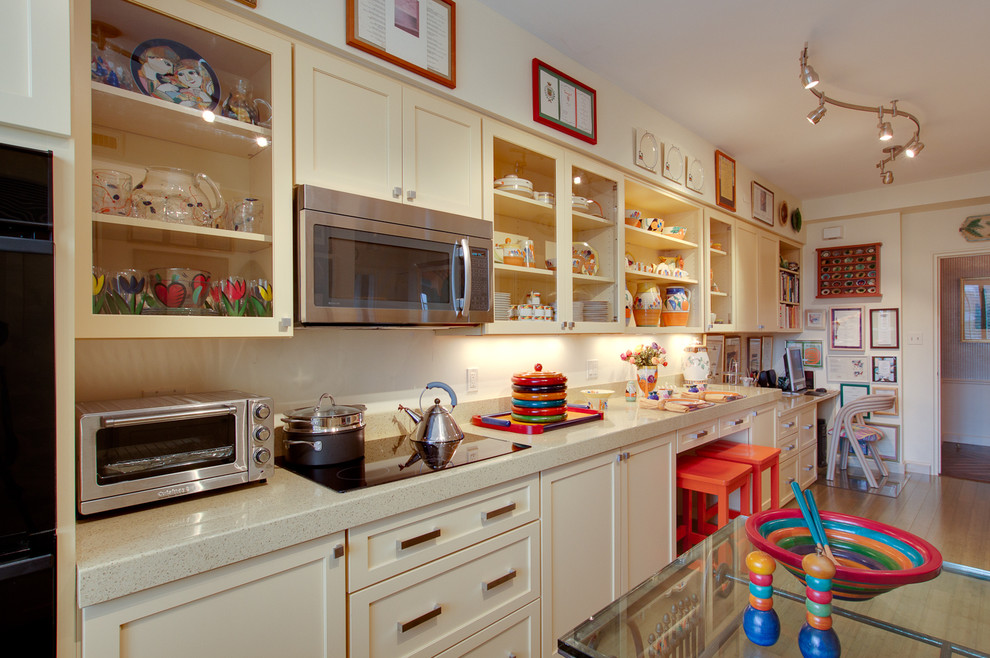 Eclectic kitchen in DC Metro with glass-front cabinets.