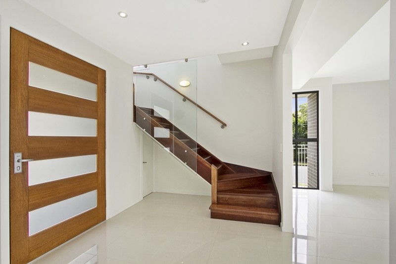 Design ideas for a small contemporary front door in Gold Coast - Tweed with white walls, ceramic floors, a single front door, a medium wood front door and beige floor.