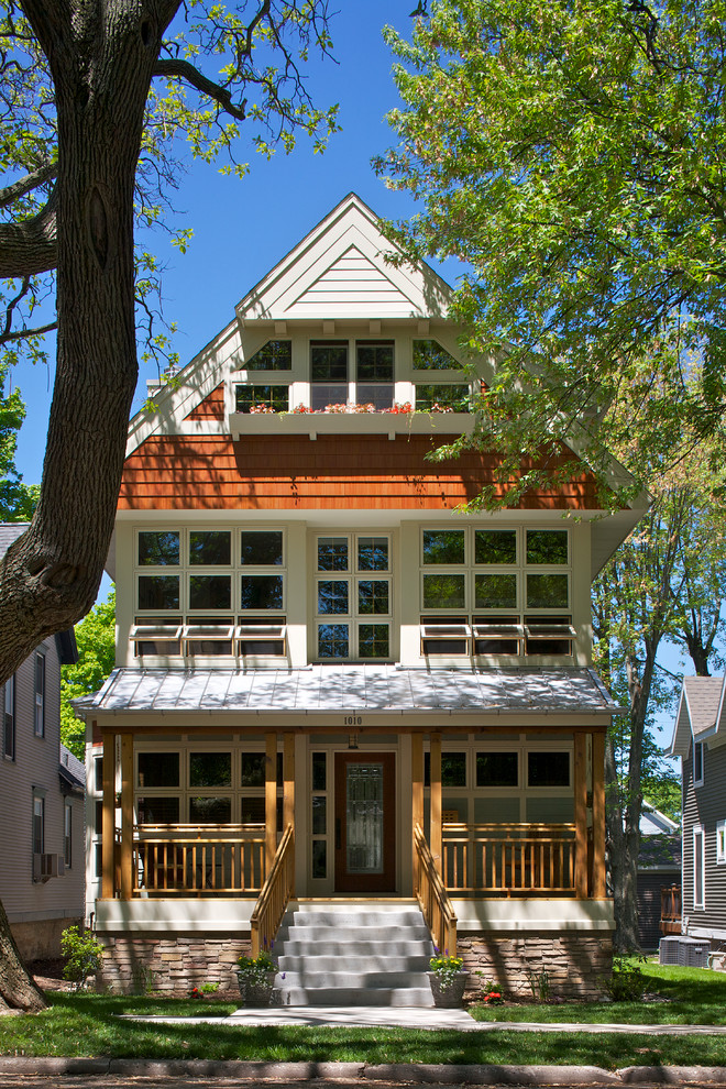 Design ideas for a traditional three-storey exterior in Other with wood siding.