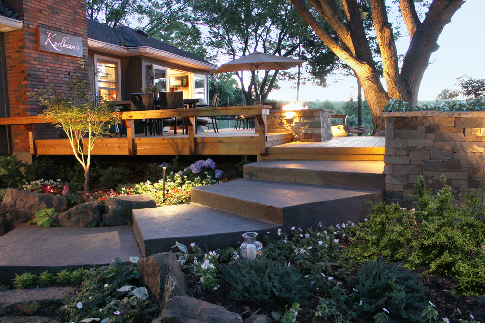 Large contemporary backyard deck in Kansas City with a fire feature and no cover.