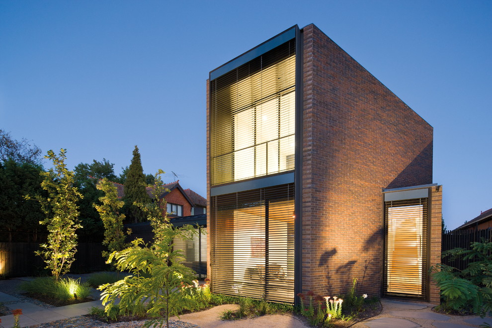 Photo of a large modern two-storey brick brown exterior in Melbourne.