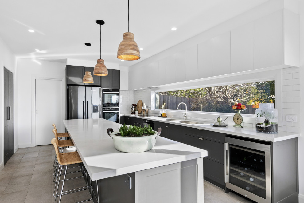 Inspiration for a large transitional kitchen in Geelong with a double-bowl sink, shaker cabinets, grey cabinets, quartz benchtops, stainless steel appliances, ceramic floors, with island, grey floor and white benchtop.