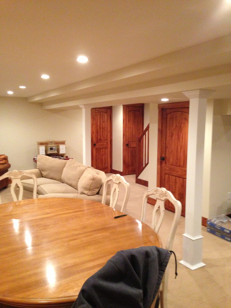 Photo of a beach style basement in New York.