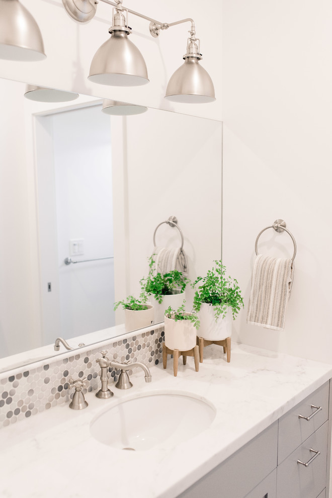 Inspiration for a mid-sized transitional kids bathroom in San Francisco with shaker cabinets, grey cabinets, an alcove tub, a shower/bathtub combo, gray tile, mosaic tile, white walls, marble floors, an undermount sink, marble benchtops and a shower curtain.