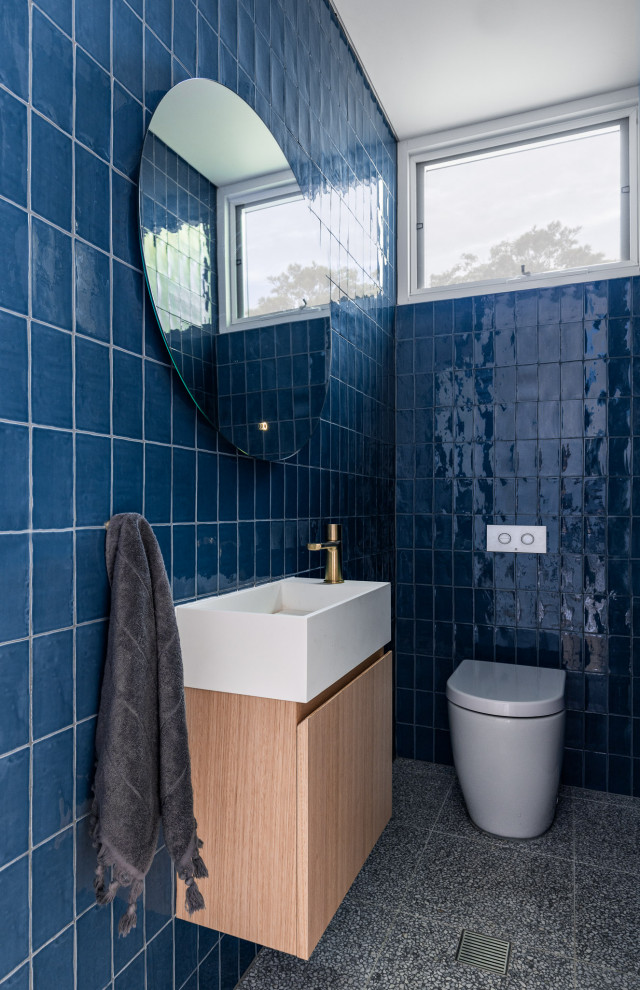 Small contemporary master bathroom in Sydney with open cabinets, light wood cabinets, a freestanding tub, an open shower, a two-piece toilet, blue tile, ceramic tile, blue walls, terrazzo floors, engineered quartz benchtops, grey floor, an open shower, white benchtops, a single vanity and a floating vanity.