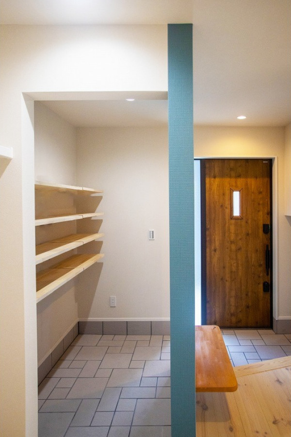 Example of a wallpaper ceiling and wallpaper entryway design in Other with a dark wood front door