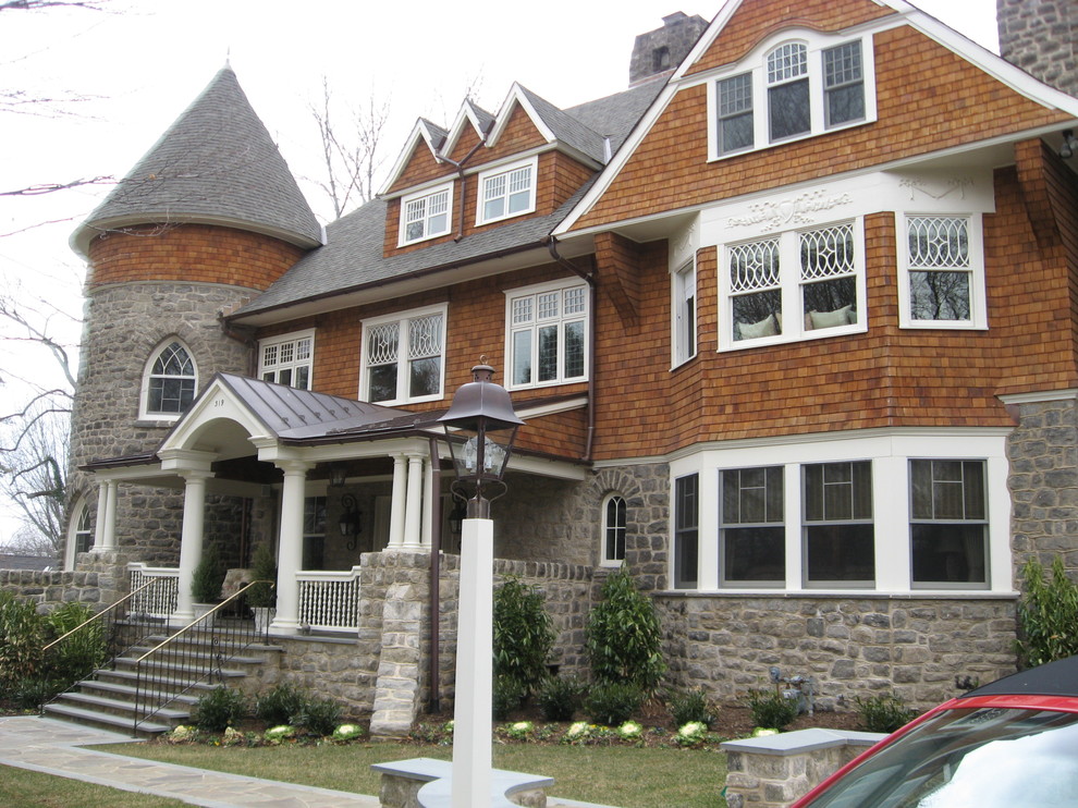Photo of a large traditional two-storey brown house exterior in Philadelphia with mixed siding, a gable roof and a shingle roof.