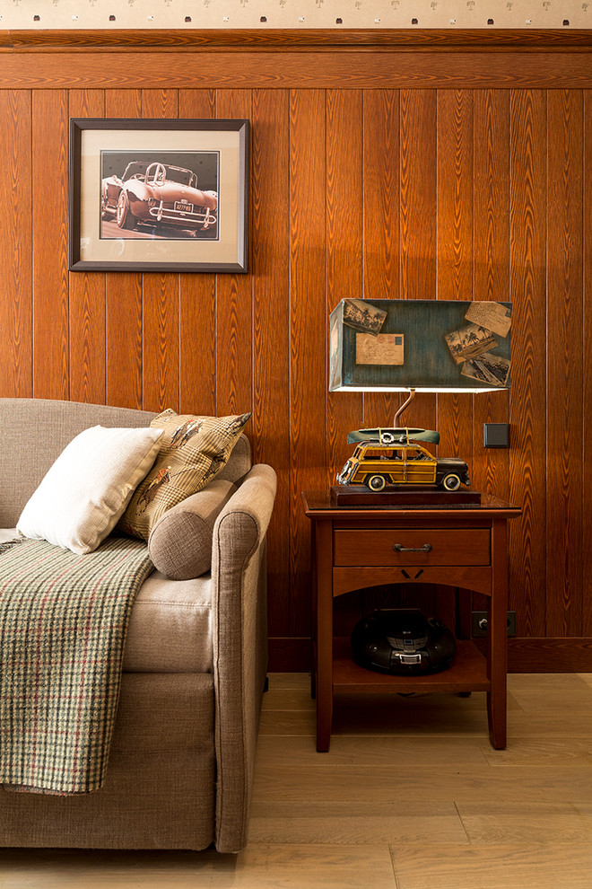 Inspiration for a mid-sized traditional kids' room for boys in Moscow with medium hardwood floors and brown walls.