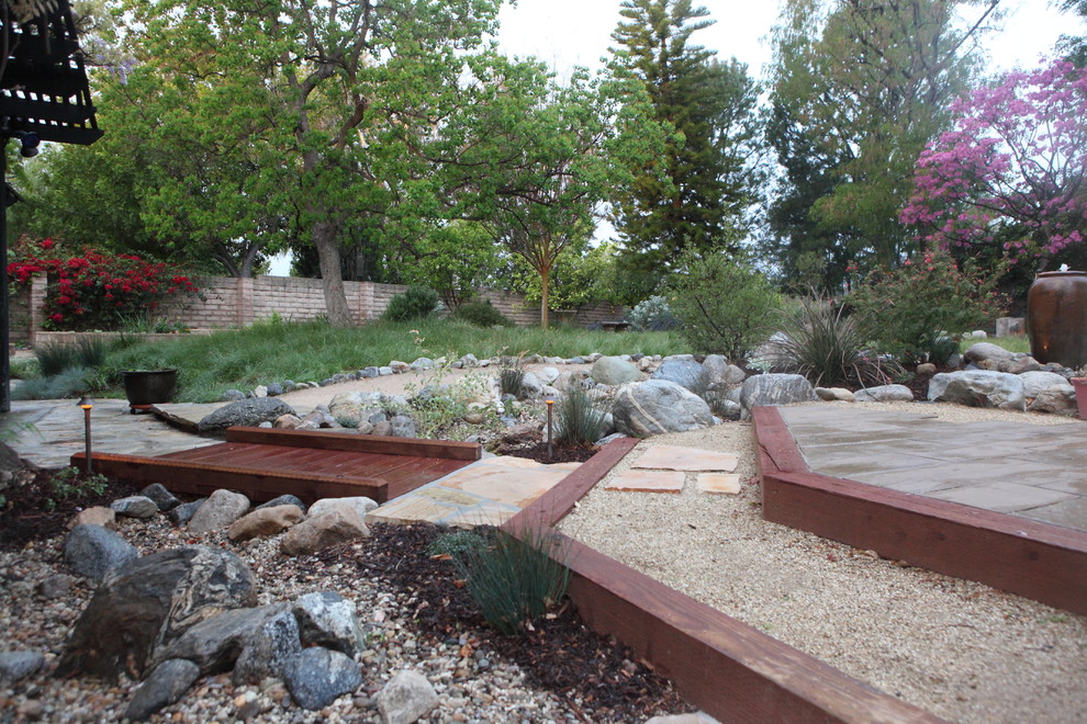 Inspiration for a country backyard garden for spring in Los Angeles with natural stone pavers.
