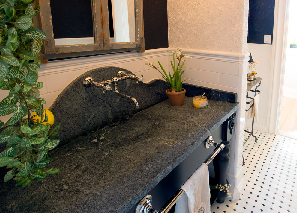 Inspiration for a mid-sized midcentury powder room in Dallas with open cabinets, black cabinets, a two-piece toilet, white tile, ceramic tile, black walls, mosaic tile floors, an undermount sink, marble benchtops and black benchtops.