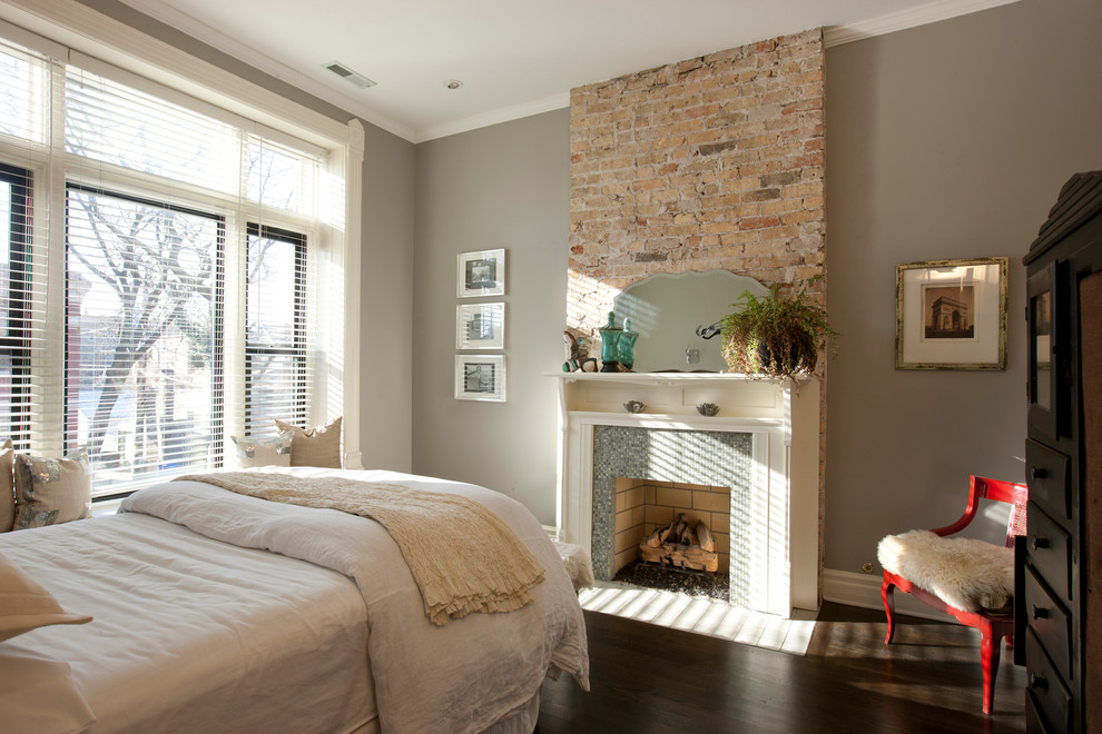 Transitional bedroom in Chicago with grey walls, dark hardwood floors, a standard fireplace and a tile fireplace surround.