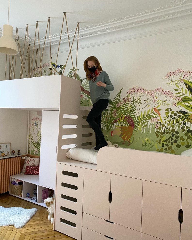 Large contemporary gender neutral children’s room in Paris with white walls and wallpapered walls.