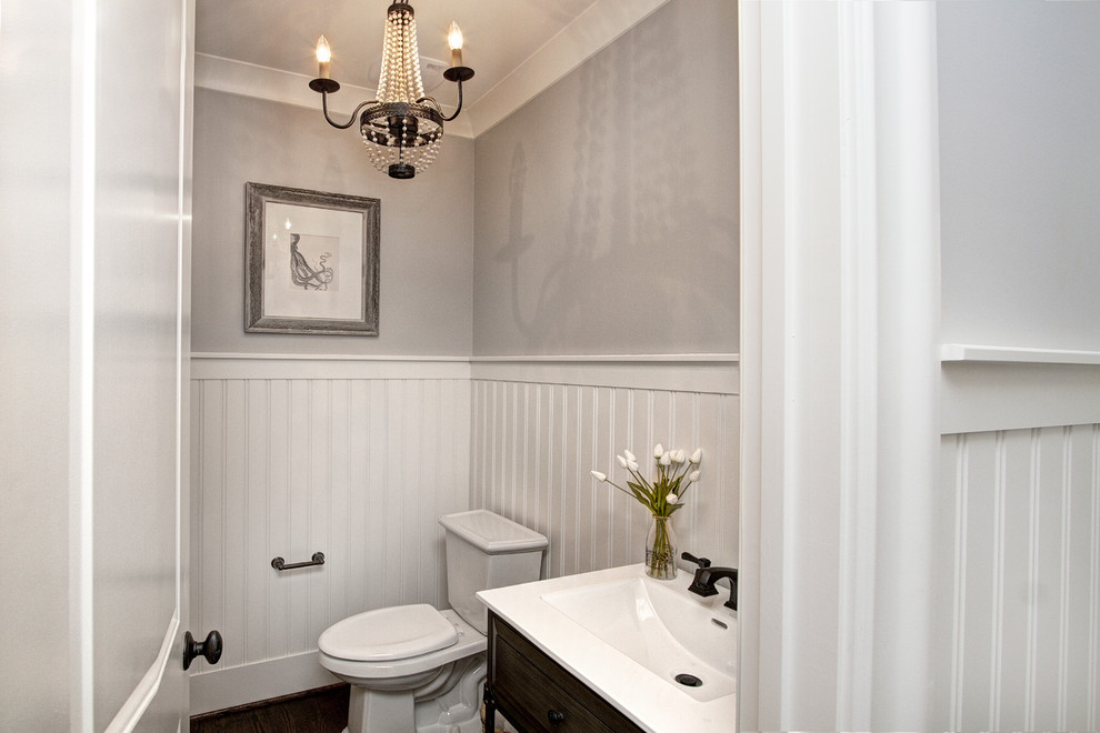 Design ideas for a small transitional powder room in Charlotte with dark wood cabinets, a two-piece toilet, grey walls, dark hardwood floors and a vessel sink.