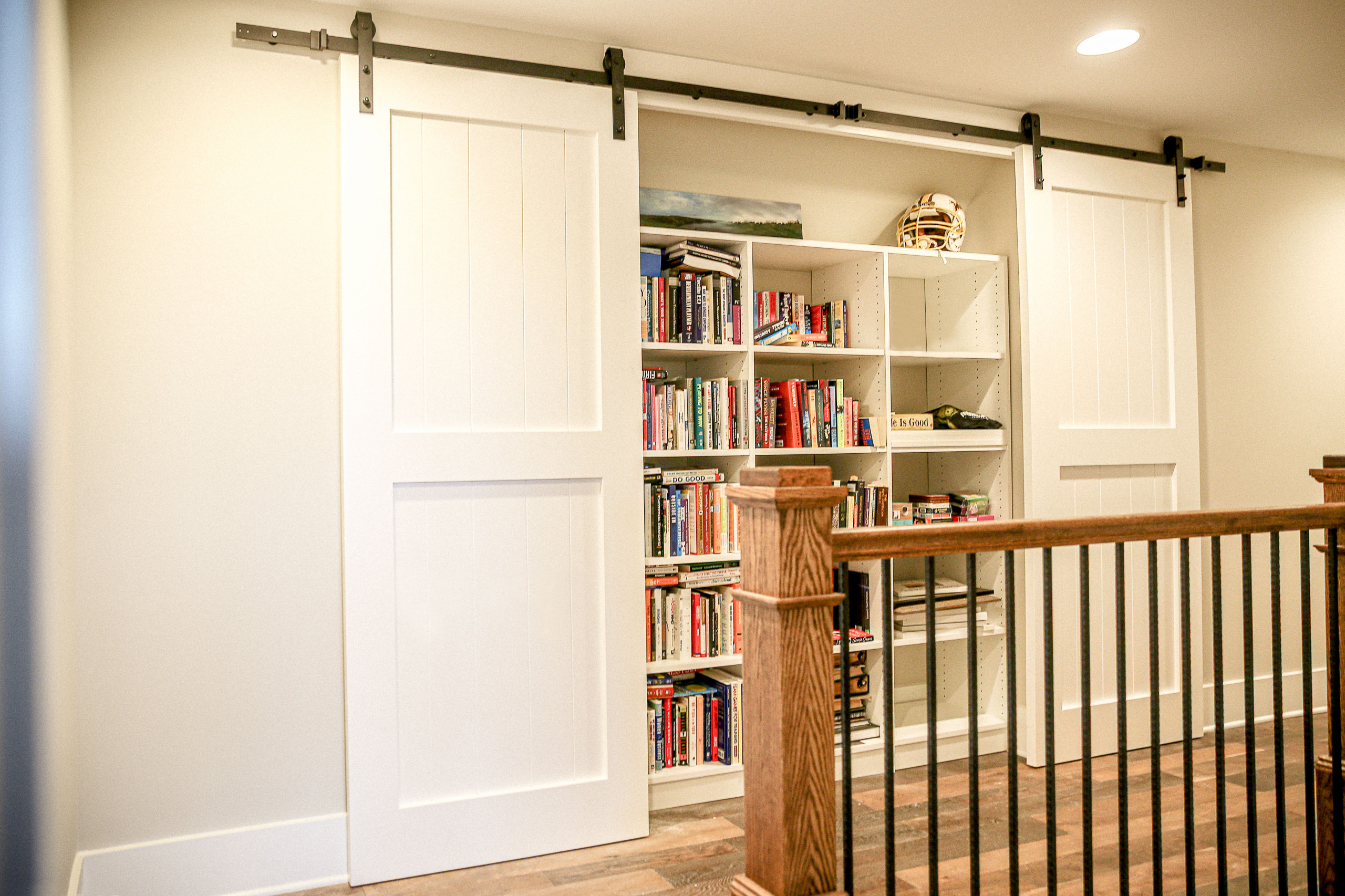 Custom made sliding barn doors to cover a custom made book shelf.