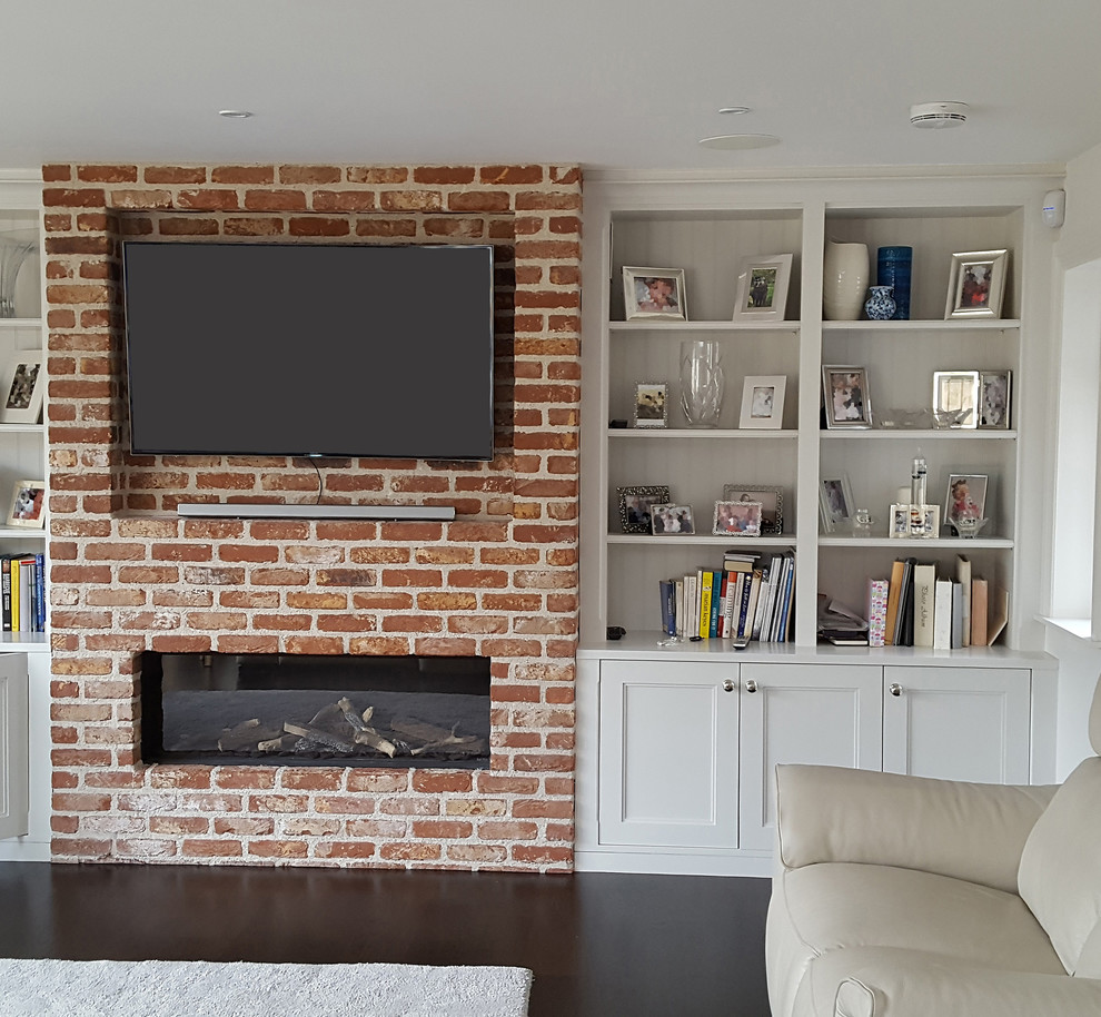 Photo of a contemporary living room in Dublin with white walls, dark hardwood flooring, a ribbon fireplace, a brick fireplace surround and a wall mounted tv.