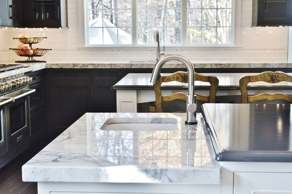Inspiration for a large transitional l-shaped dark wood floor enclosed kitchen remodel in DC Metro with an undermount sink, dark wood cabinets, white backsplash, subway tile backsplash, stainless steel appliances, two islands and shaker cabinets