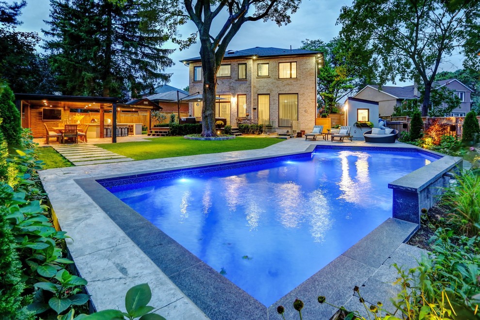 Pool house - mid-sized transitional backyard stamped concrete and rectangular pool house idea in Toronto