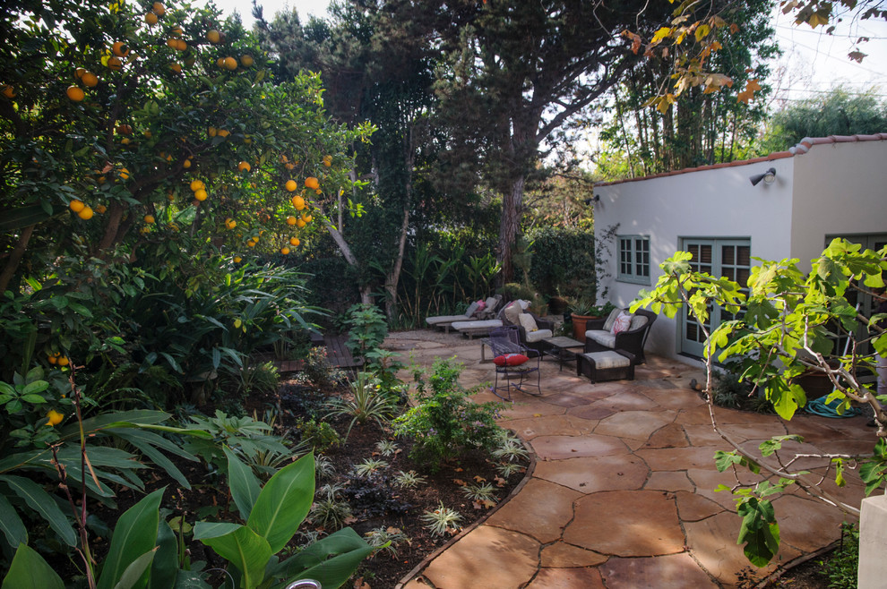 Mid-sized contemporary backyard patio in Los Angeles with an outdoor shower, natural stone pavers and no cover.