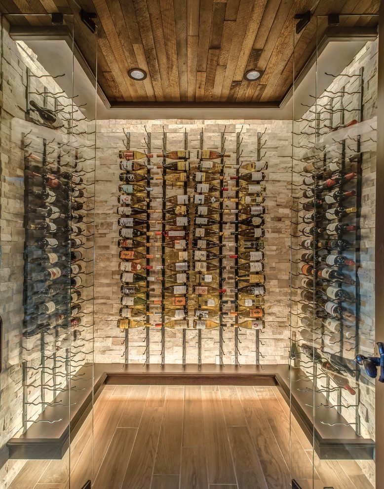 Design ideas for a large transitional wine cellar in Detroit with porcelain floors and display racks.