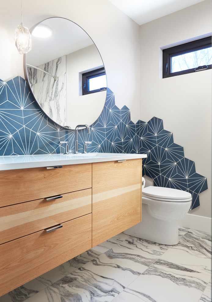 This is an example of a small transitional 3/4 bathroom in Edmonton with flat-panel cabinets, light wood cabinets, an alcove tub, a shower/bathtub combo, a one-piece toilet, gray tile, cement tile, ceramic floors, an undermount sink, engineered quartz benchtops, white floor, a shower curtain and beige walls.