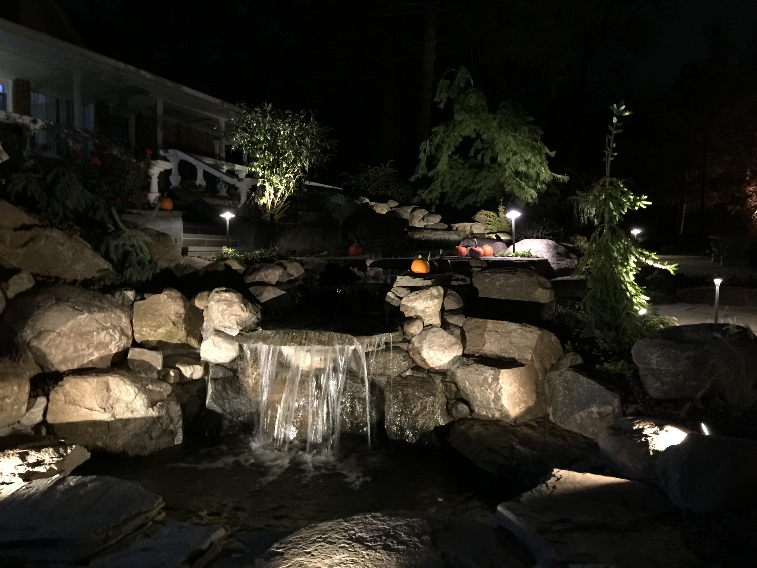 waterfall stream with stone bridge and natural bluestone walkwayway and steps