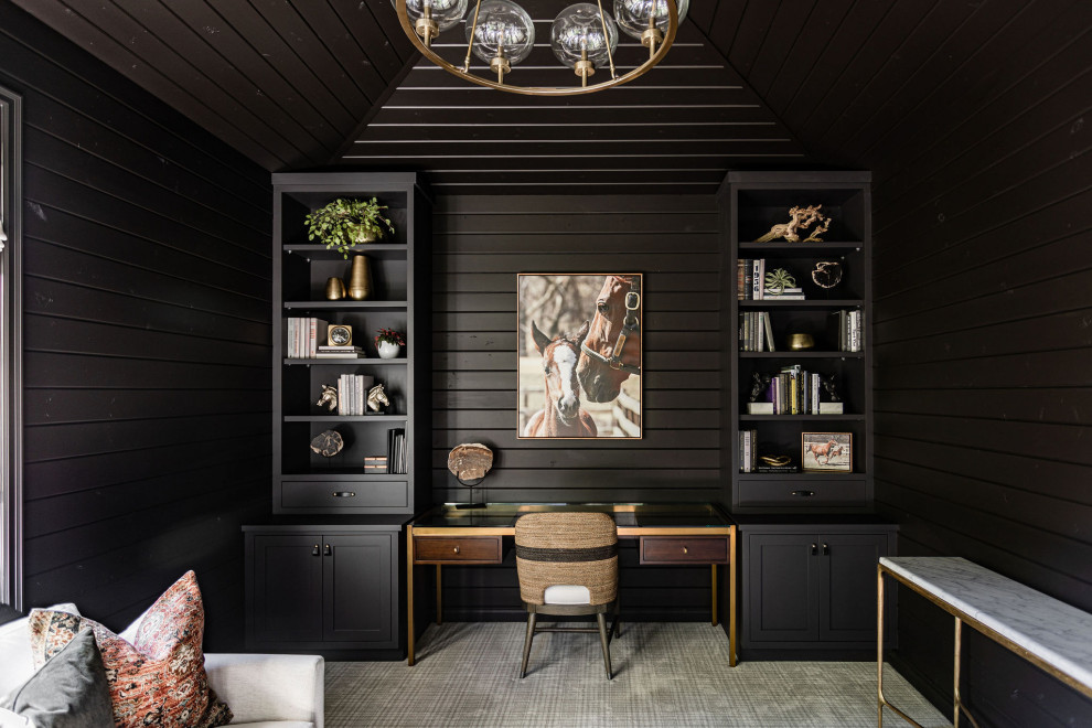 This is an example of a small transitional study room in Minneapolis with black walls, carpet, a built-in desk, multi-coloured floor, wood and wood walls.